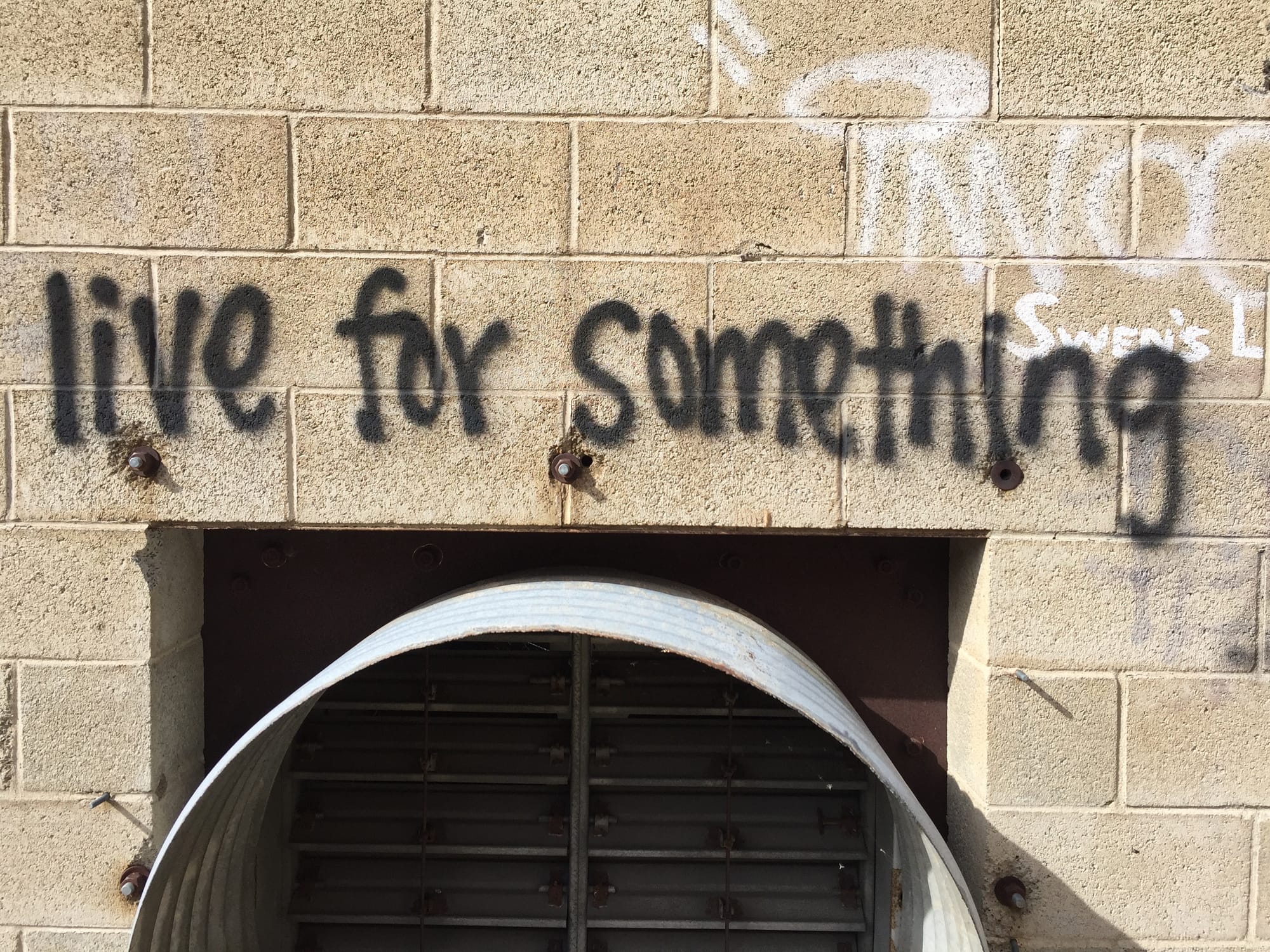 Spray paint graffiti stating Live for Something